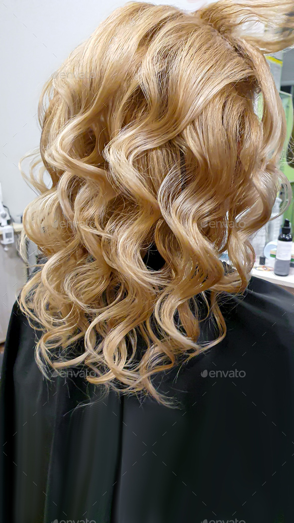 Hairstyle, curls and strands in a beauty salon. Long hair, beauty and