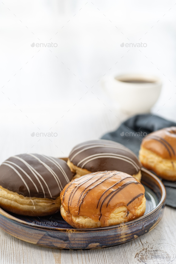 Donut or bun made from sweet yeast dough stuffed with chocolate or cream with icing.