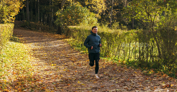 Jogging warm up every day healthy lifestyle. Man training in the afternoon autumn cold season