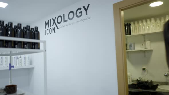 Young Colombian Woman Using Electronic Device While Getting Hair Combed at the Salon alt