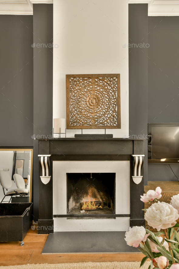a living room with a fireplace and a flower arrangement