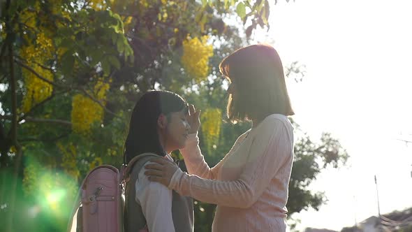 Asian Mother Talking Her Daughter With Backpack Outdoors, Back To School alt