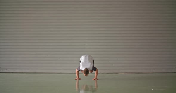Young Adult Man Doing Handstand Exercise During Fitness Sport Workout