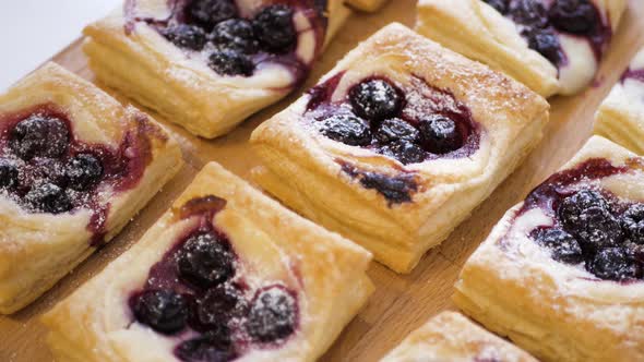 Homemade cakes are lying on the table, hand takes one cake