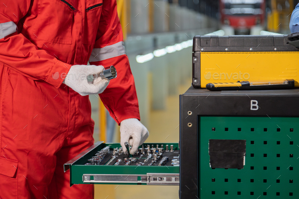 Maintenance engineers select tools for rail work in a railway maintenance center.