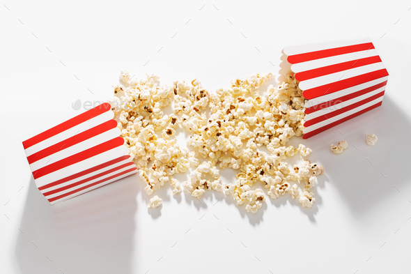 Classic striped bucket with delicious popcorn on white background