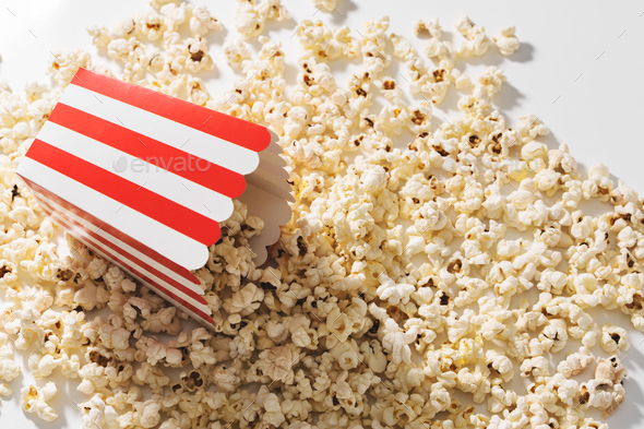 Classic striped bucket with delicious popcorn on white background
