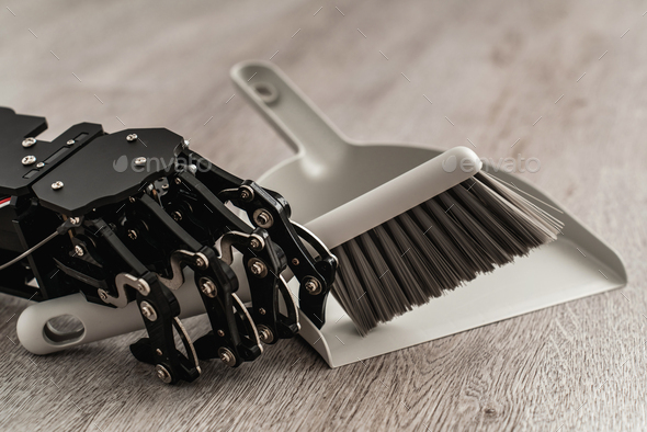 Robotic hand skillfully using a dustpan and brush to sweep the floor