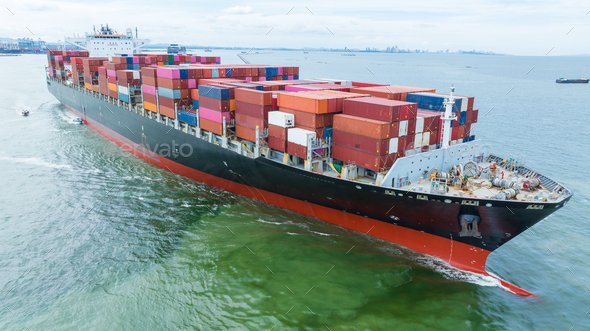 Aerial side view of cargo container ship carrying container from custom ...