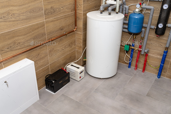 Modern gas boiler room lined with ceramic tiles imitating wood, emergency power supply 12V battery.