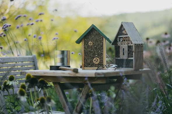 Wooden insect house outdoors in the garden. Bug hotel as home for various species of insects, garden