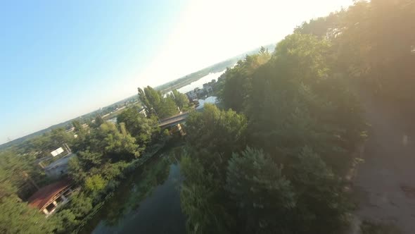 FPV Drone View Quickly Flies Near an Unfinished Apartment Building and Over the Beach with Calm alt
