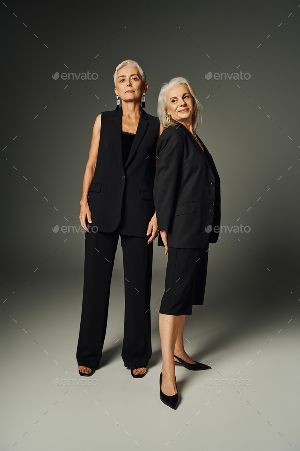 full length of graceful elderly women in black stylish clothing