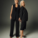 full length of graceful elderly women in black stylish clothing