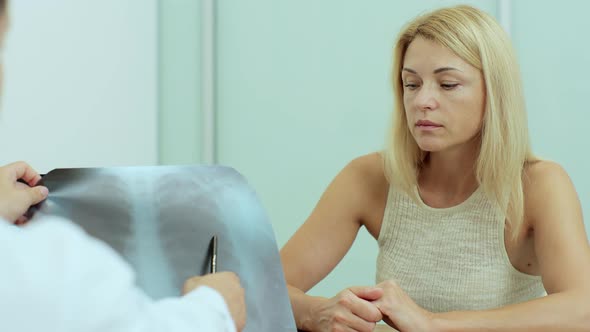 Young Male Doctor Checking Xray Lungs Consulting a Patient Positive for Coronavirus Supporting alt