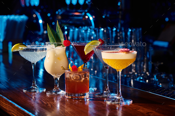 six different topical and elegant cocktails with bar cabinet on background, concept