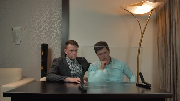 Two Friends in Shirts Sit Behind Virtual Glass Peace. Ready for Your Infographics. alt