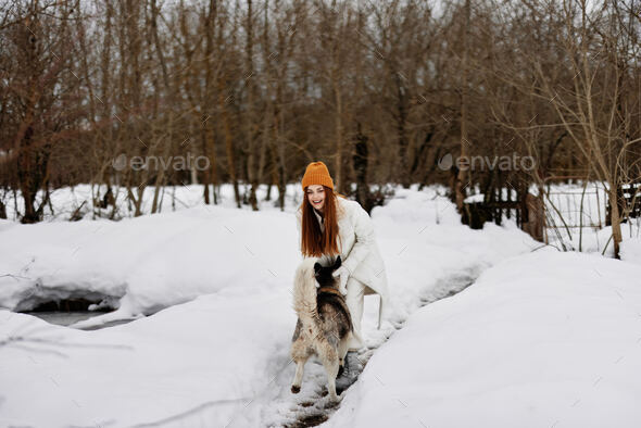 young woman in winter clothes in hats outdoors There is a lot of snow  around Stock Photo by shotprime