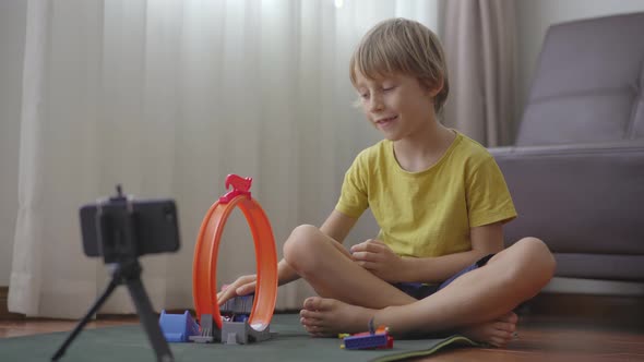 A Little Boy Plays and Talks with His Friends and Relatives Through a Video-call Using a Smartphone alt