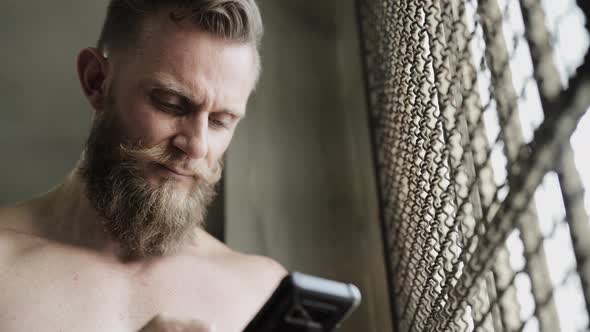 Man with Bandholz Beard Texting on Phone alt
