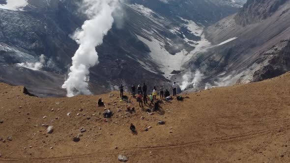 people at a steaming volcano