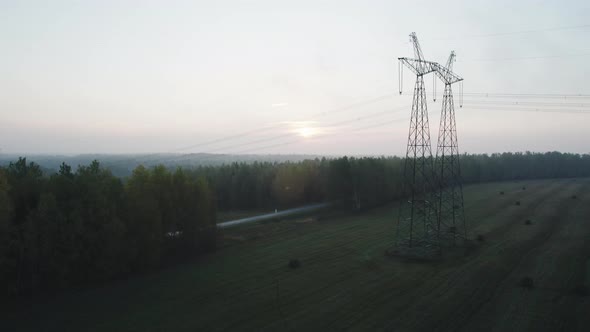 Power Line Support with High Voltage Wires in a Wooded Area alt