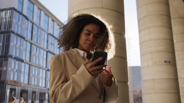 Young Biracial Woman Types Messages to Boyfriend Smiling alt