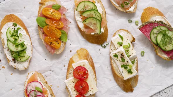 Variety of Small Sandwiches with Cream Cheese Vegetables and Salami