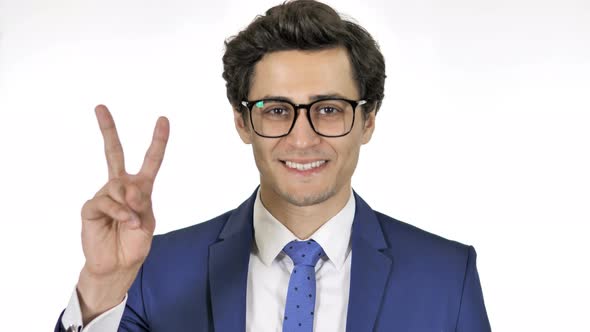 Sign of Victory by Young Businessman Isolated on White Background alt