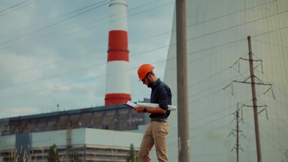 Engineer In Hard Hat Maintenance Electricity Transmission Pylon.Constructor Checking High Voltage alt
