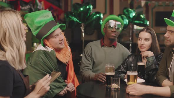 Friends Making Order In Irish Pub alt