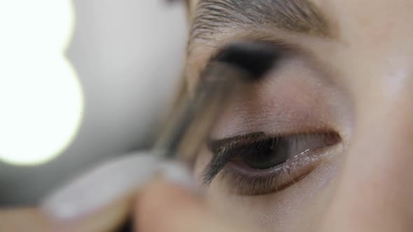 Makeup of Eyes for Young Woman in Beauty Salon From Makeup Artist Eye Closeup
