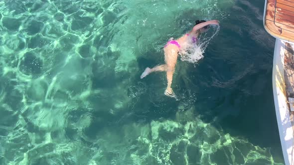 Young Girl Swimming in Clear Turquoise Sea Water