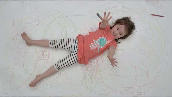 Little Girl Dabbles on Camera on Painted Floor alt