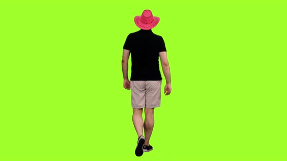 Back View of Man Tourist Walking in Pink Cowboy Hat