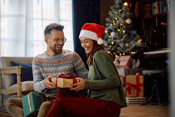 Couple exchanging Christmas gifts