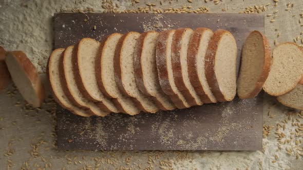 Sliced Bread Falling in Slow Motion. Top View of Wholegrain Bread Falling Down. alt