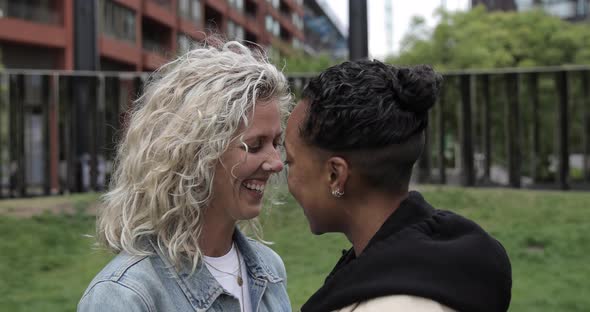Happy mixed race lesbian couple in love kissing and cuddling - Girlfriends, m alt