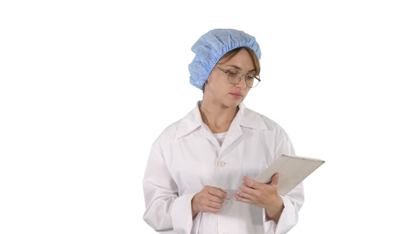 Young positive doctor woman taking notes on tablet and alt