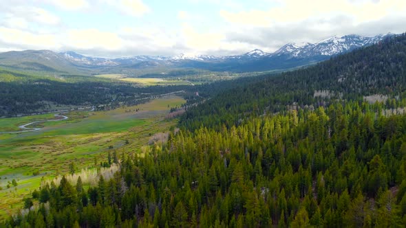 Aerial View Flight Over Picturesque Landscape of Snowcapped Alpine Mountains on the Horizon alt