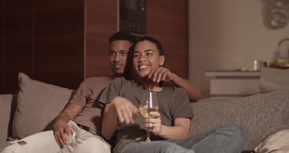 Happy Couple Choosing Film to Watch alt