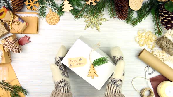 Hands in gloves taking /giving a present alt