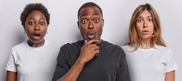 Horizontal Shot Of Stunned African Woman Stupefied Dark Skinned Man