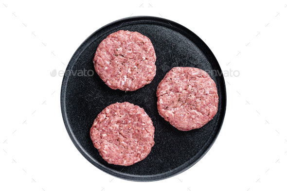 Raw chicken turkey patty, minced meat cutlets on a plate with thyme. Isolated on white background.