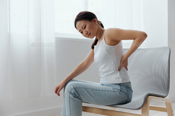 Suffering from scoliosis osteochondrosis after long study pretty young Asian woman feel hurt joint