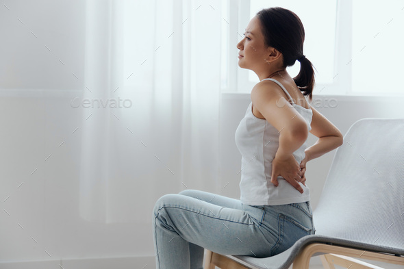 Suffering from scoliosis osteochondrosis after long study pretty young Asian woman feel hurt joint