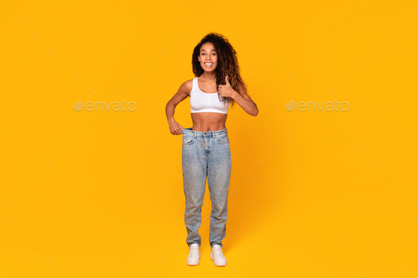 Black Lady Showing Successful Weight Loss Gesturing Thumbs Up, Studio