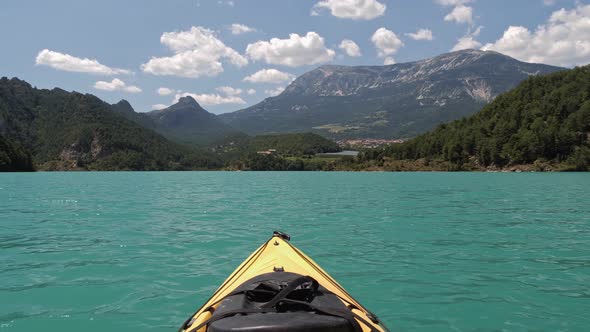First Person View Looking From Yellow Kayak Swaying on Waves of Emerald Lake alt