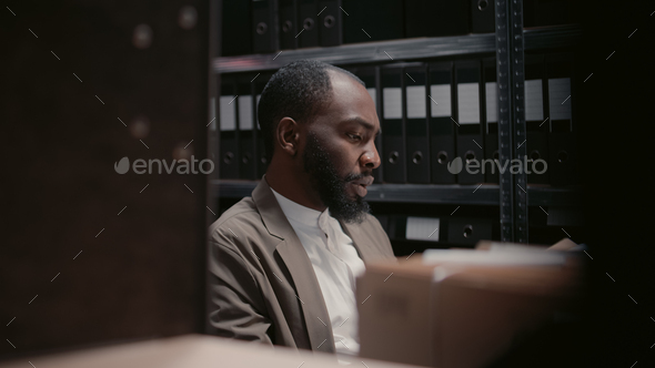 African american man working on criminal case with files