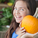 Girl Holding a Pumpkin at the Farmers Market. - PhotoDune Item for Sale